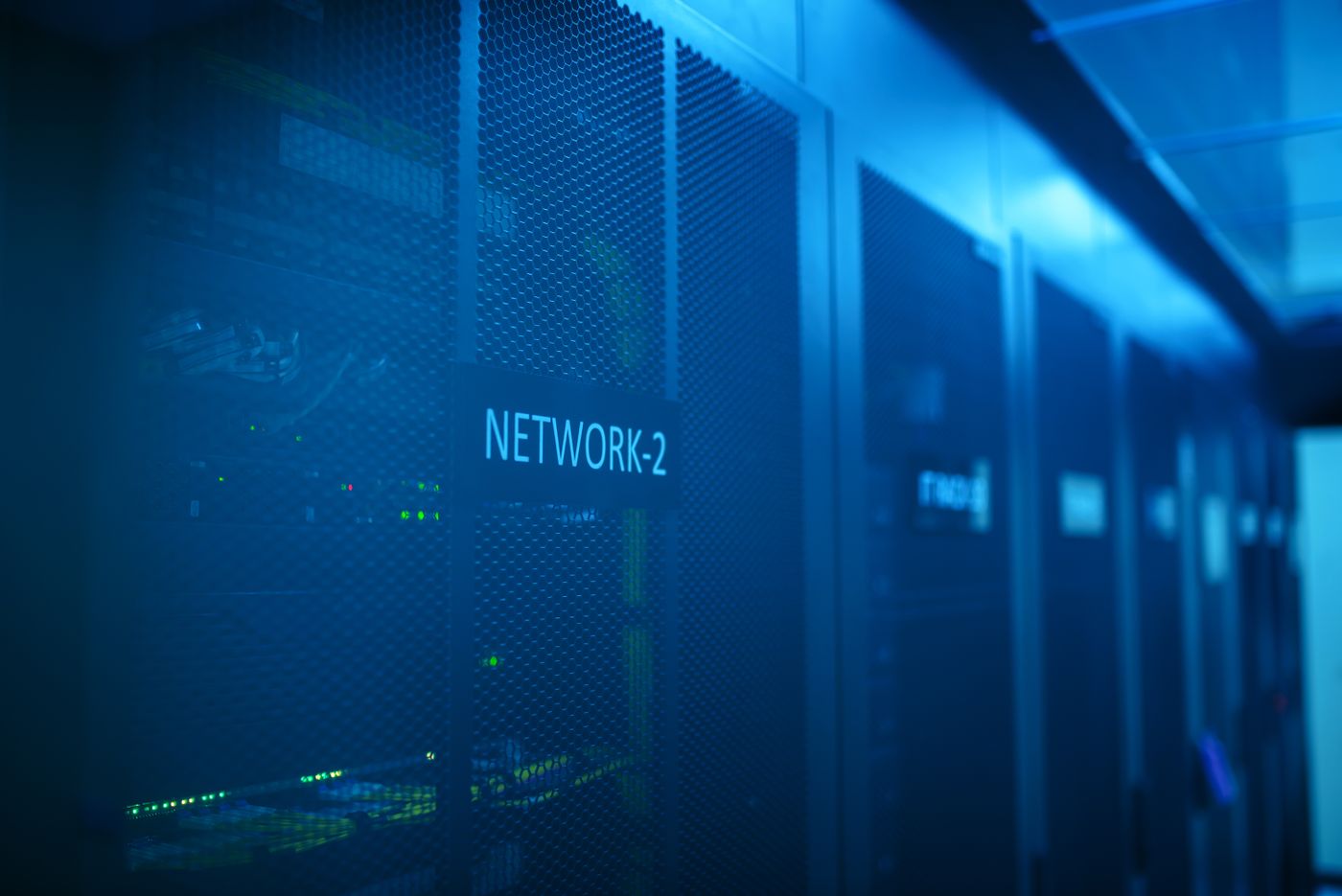 Corredor de racks de servidores com iluminação azul em um data center